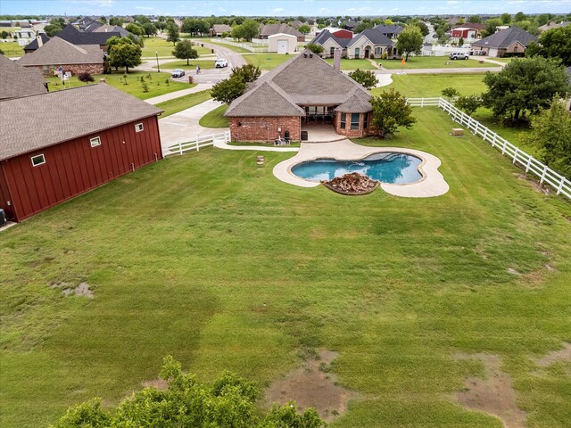 pool featuring a yard, a residential view, a fenced backyard, and a patio area