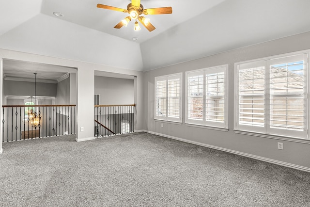 empty room with carpet floors, ceiling fan, baseboards, and vaulted ceiling