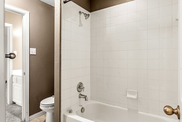 full bath featuring shower / bath combination, a textured wall, and toilet