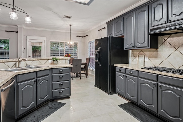 kitchen featuring crown molding, appliances with stainless steel finishes, tasteful backsplash, a sink, and light countertops