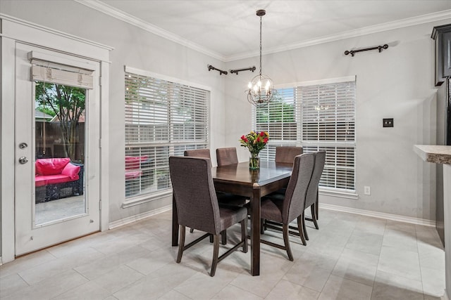 dining room with baseboards, ornamental molding, and a notable chandelier