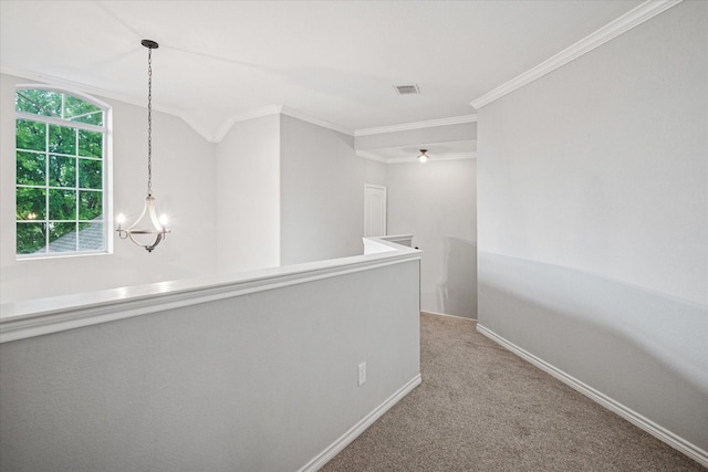corridor with visible vents, crown molding, carpet floors, baseboards, and an upstairs landing
