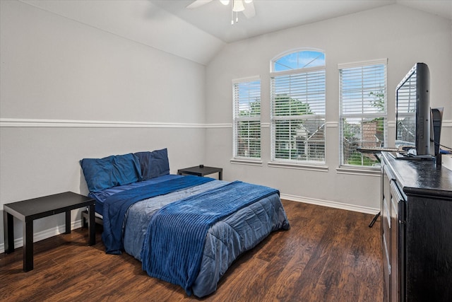 bedroom featuring a ceiling fan, baseboards, vaulted ceiling, and wood finished floors