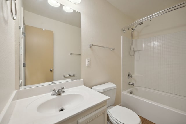 bathroom featuring vanity, shower / tub combination, and toilet