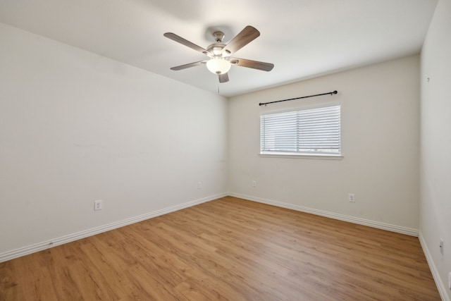 unfurnished room with ceiling fan, baseboards, and light wood-type flooring