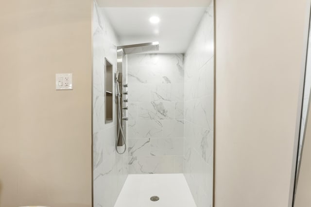 bathroom with a shower stall and recessed lighting