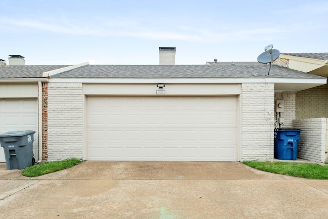 garage featuring concrete driveway