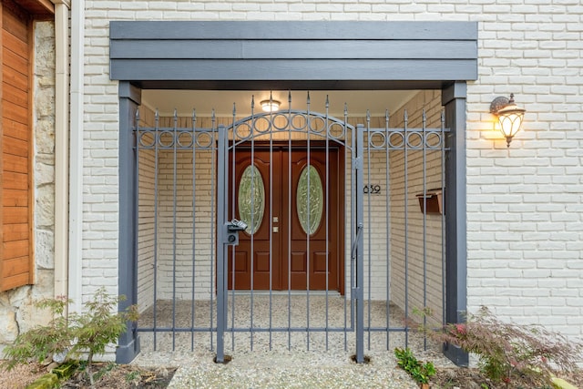 property entrance featuring brick siding