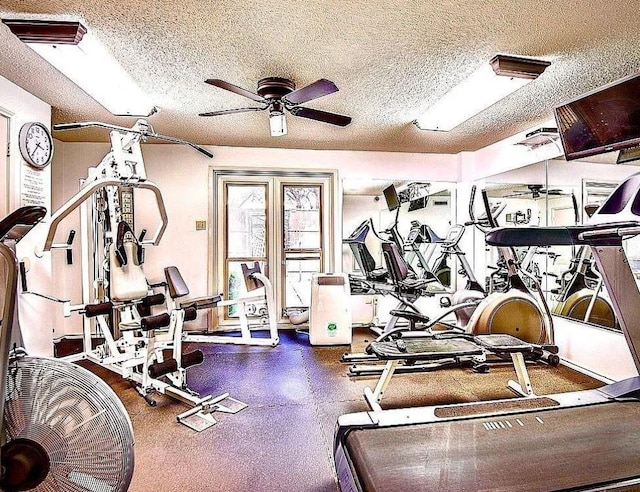 gym with a ceiling fan and a textured ceiling