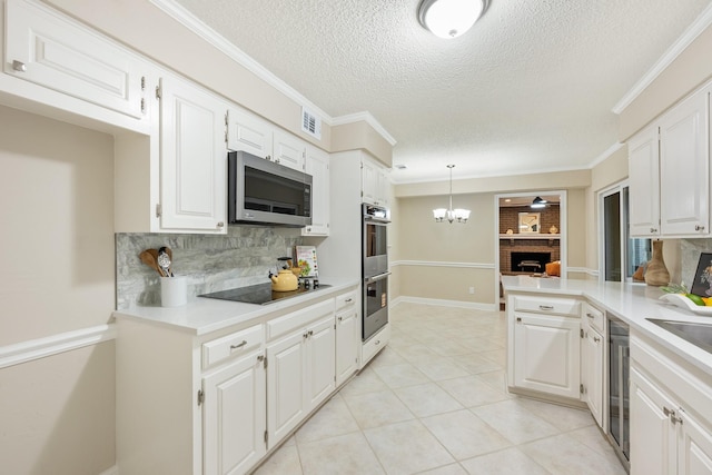 kitchen featuring backsplash, a textured ceiling, visible vents, appliances with stainless steel finishes, and light countertops