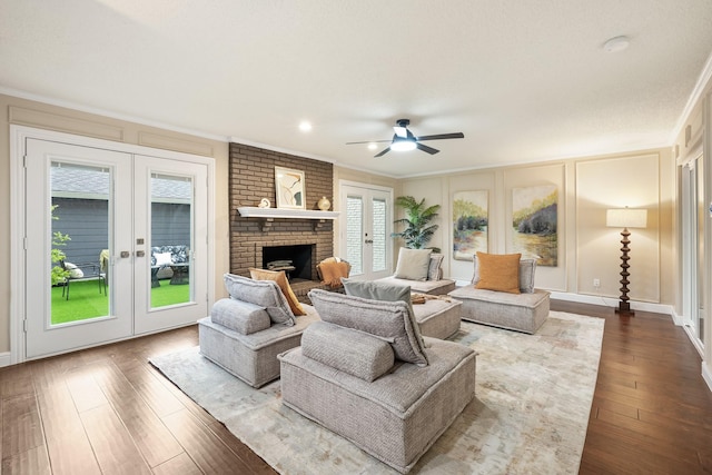 living room featuring ornamental molding, a ceiling fan, french doors, and dark wood finished floors