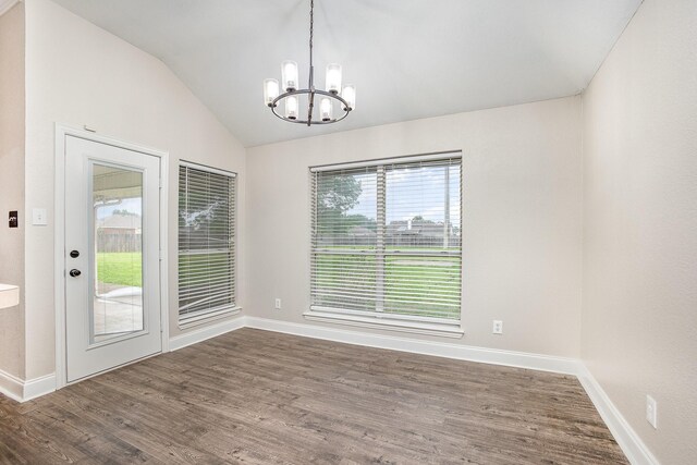 unfurnished dining area with an inviting chandelier, baseboards, dark wood-type flooring, and vaulted ceiling