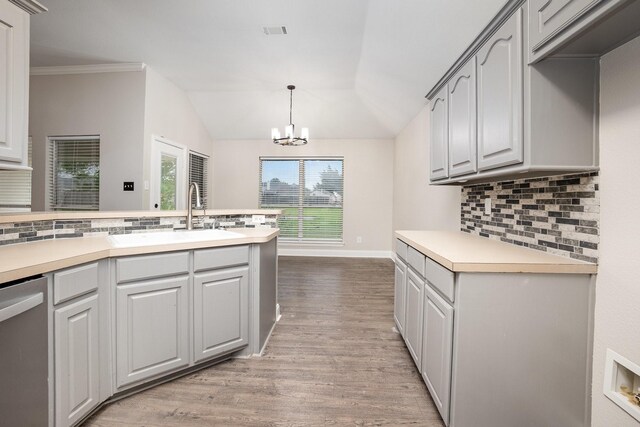 kitchen with backsplash, stainless steel dishwasher, a sink, and light wood-style flooring
