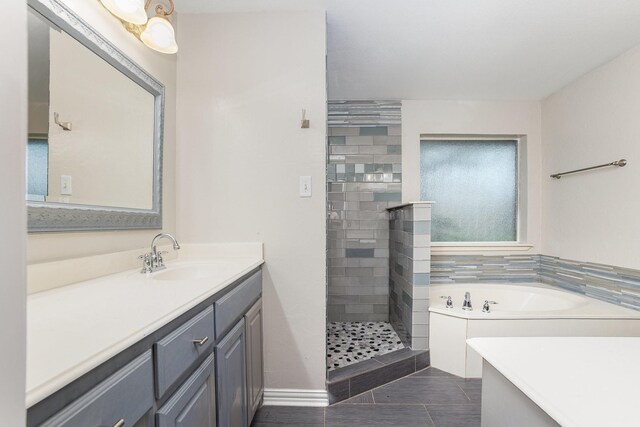 full bathroom featuring a bath, tile patterned flooring, a stall shower, vanity, and baseboards