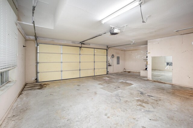 garage featuring a garage door opener and electric panel