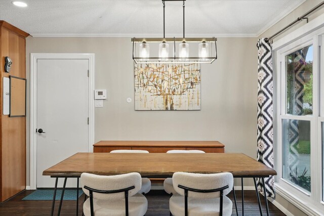 dining room featuring baseboards, ornamental molding, and dark wood finished floors