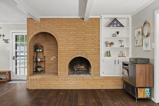 unfurnished living room with dark wood-style flooring, a textured ceiling, beam ceiling, and a fireplace