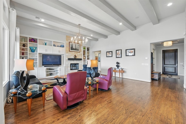 living area with baseboards, wood finished floors, a fireplace, and beamed ceiling