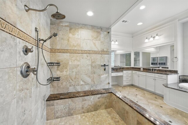 bathroom featuring recessed lighting, visible vents, and tiled shower