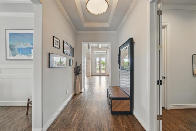 hall featuring crown molding, baseboards, and dark wood finished floors