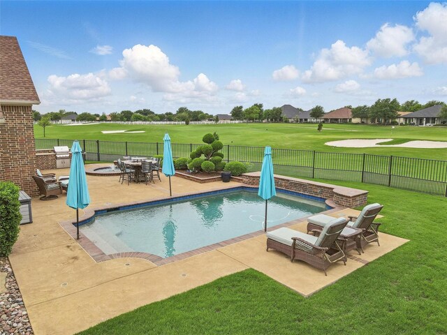 view of swimming pool with a fenced backyard, a fenced in pool, a patio area, view of golf course, and a yard