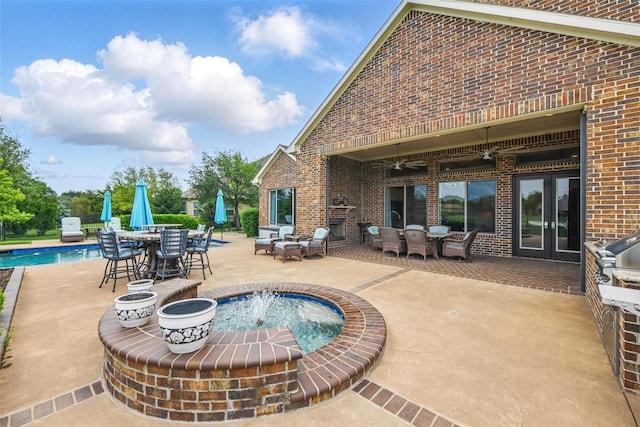 view of patio with ceiling fan, an outdoor pool, and outdoor dining space