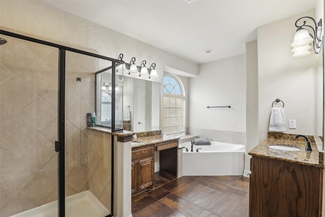full bathroom featuring vanity, a stall shower, and a garden tub