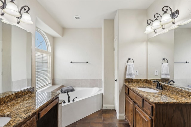 bathroom featuring vanity, tile patterned flooring, and a garden tub