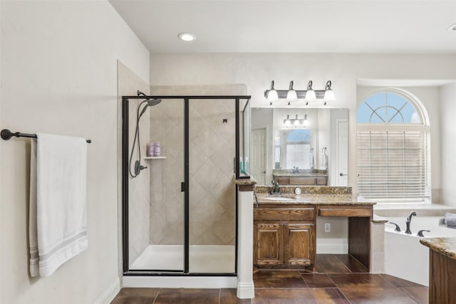 bathroom featuring vanity, tile patterned floors, a bath, and a stall shower