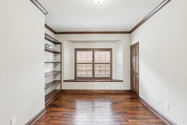 unfurnished room featuring baseboards, ornamental molding, dark wood finished floors, and built in shelves