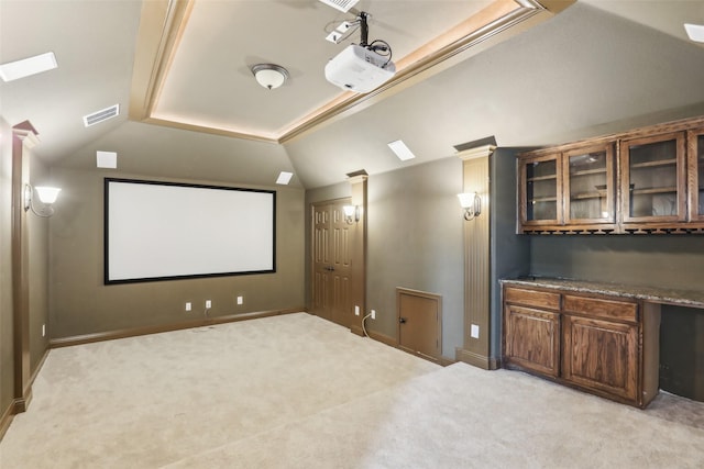 cinema room featuring baseboards, light carpet, lofted ceiling, and visible vents