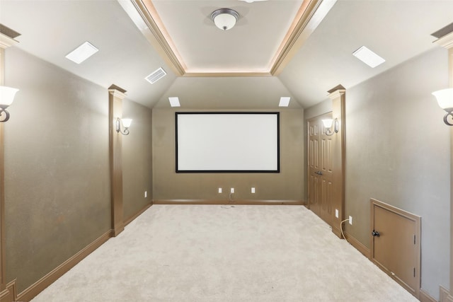 home theater featuring visible vents, decorative columns, carpet flooring, and lofted ceiling