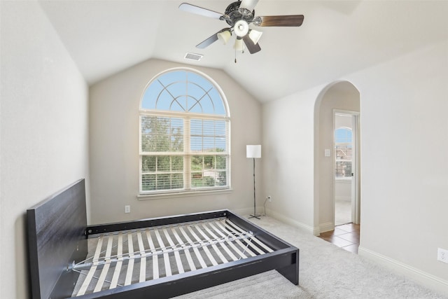 unfurnished bedroom with visible vents, multiple windows, and carpet
