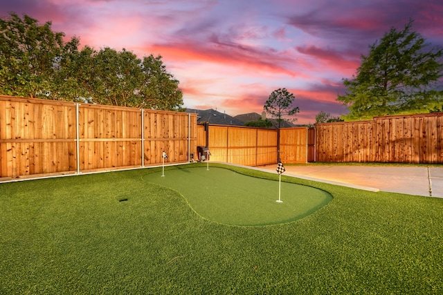 3501 Washington Dr, Frisco, TX 75034 - fenced backyard featuring a putting green and a patio area
