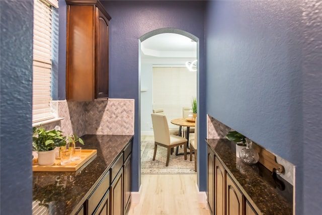 3501 Washington Dr, Frisco, TX 75034 - hallway featuring arched walkways, light wood-style flooring, and a textured wall