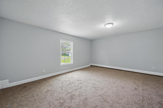 empty room featuring baseboards, a textured ceiling, and carpet