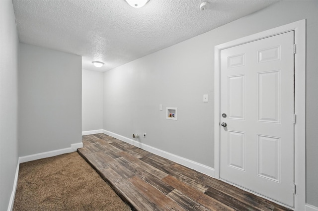 interior space with laundry area, wood finished floors, baseboards, hookup for a washing machine, and a textured ceiling