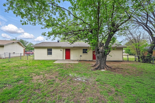back of property featuring a yard and a fenced backyard