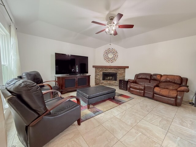 living room featuring a ceiling fan, marble finish floor, lofted ceiling, and a fireplace