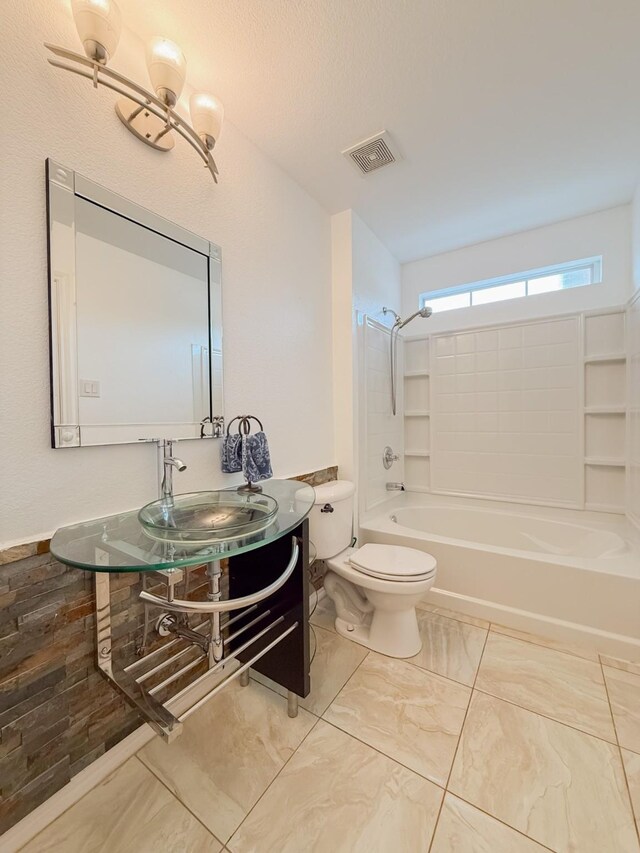 full bath featuring visible vents, vanity, marble finish floor, bathing tub / shower combination, and toilet