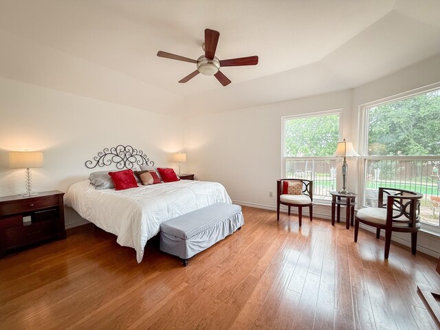 bedroom with baseboards, ceiling fan, and wood finished floors