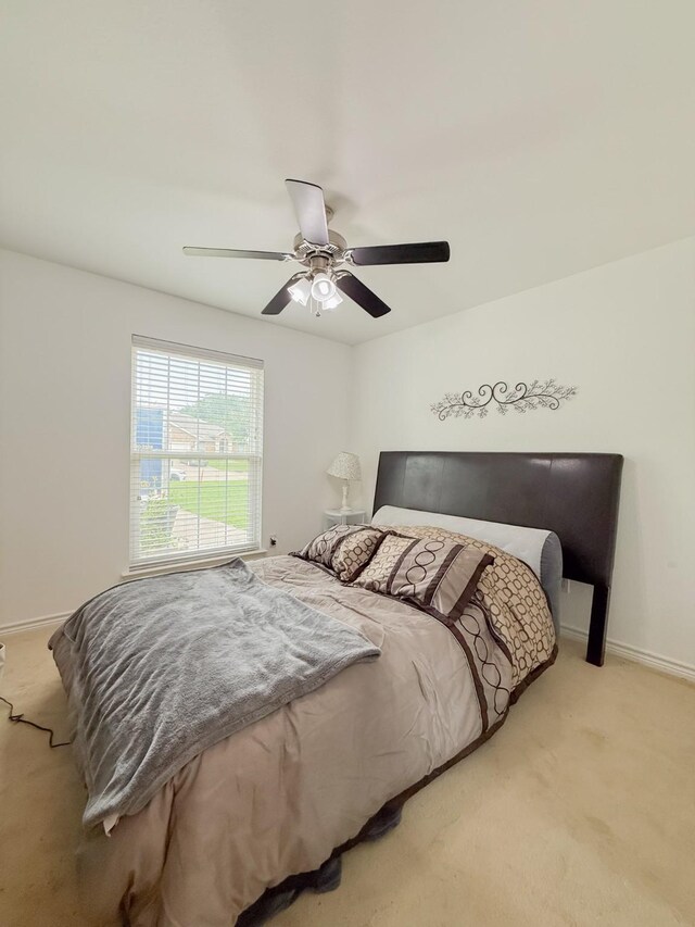 bedroom featuring baseboards, ceiling fan, and carpet flooring