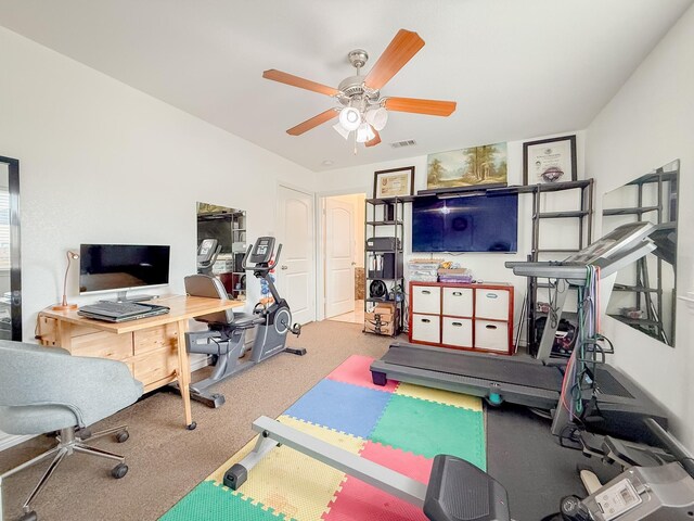 workout area featuring visible vents, a ceiling fan, and carpet flooring