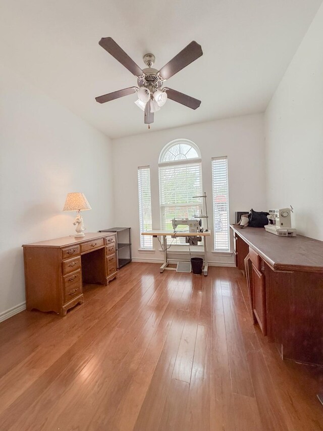office with light wood-type flooring, baseboards, and ceiling fan