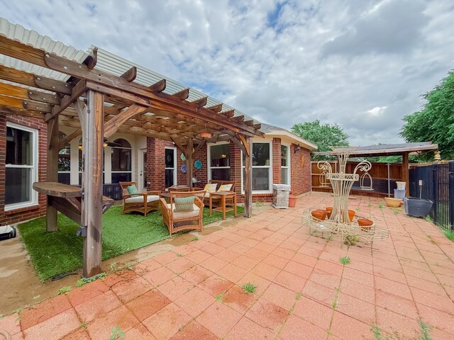 view of patio featuring fence, a pergola, and an outdoor hangout area