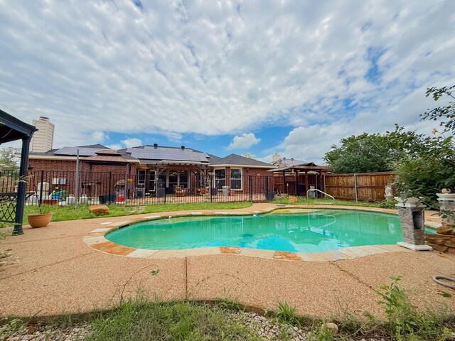 view of swimming pool with a fenced in pool, a fenced backyard, and a patio area