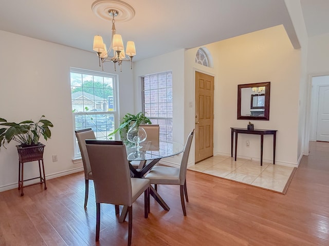 200 Meadowside Dr, Mansfield, TX 76063 - dining area with a chandelier, wood finished floors, arched walkways, and baseboards