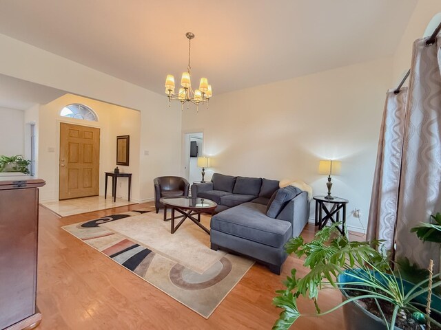 living area featuring an inviting chandelier and light wood finished floors