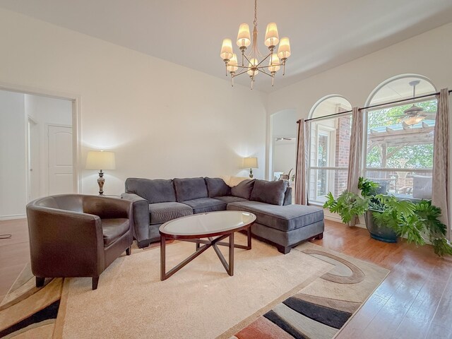 living room featuring light wood-type flooring and a chandelier
