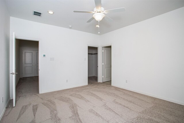 unfurnished bedroom with visible vents, carpet flooring, and baseboards
